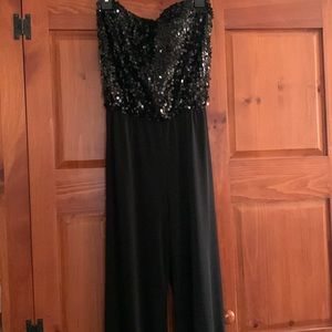 Woman’s strapless black jumpsuit with sequin top